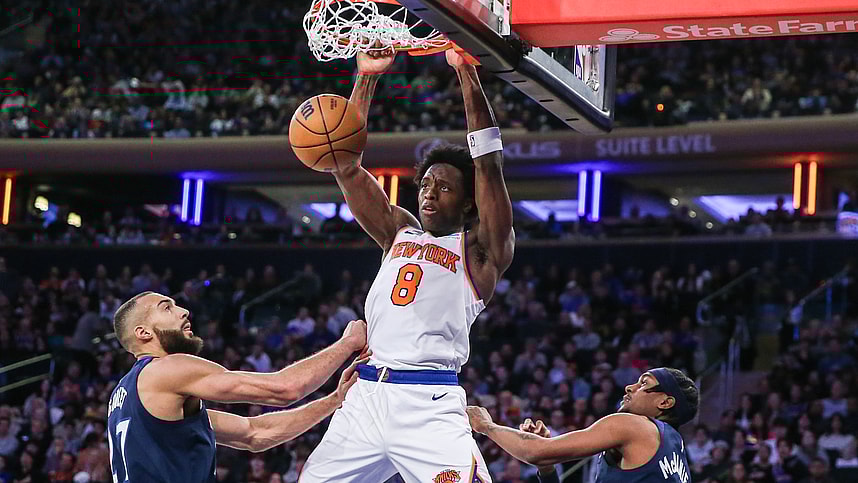 New York Knicks forward OG Anunoby (8) dunks past Minnesota Timberwolves center Rudy Gobert (27) in the third quarter at Madison Square Garden