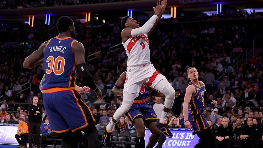 Toronto Raptors guard RJ Barrett (9) drives to the basket against New York Knicks forwards Julius Randle (30) and OG Anunoby (8) and guard Donte DiVincenzo (0) during the third quarter at Madison Square Garden