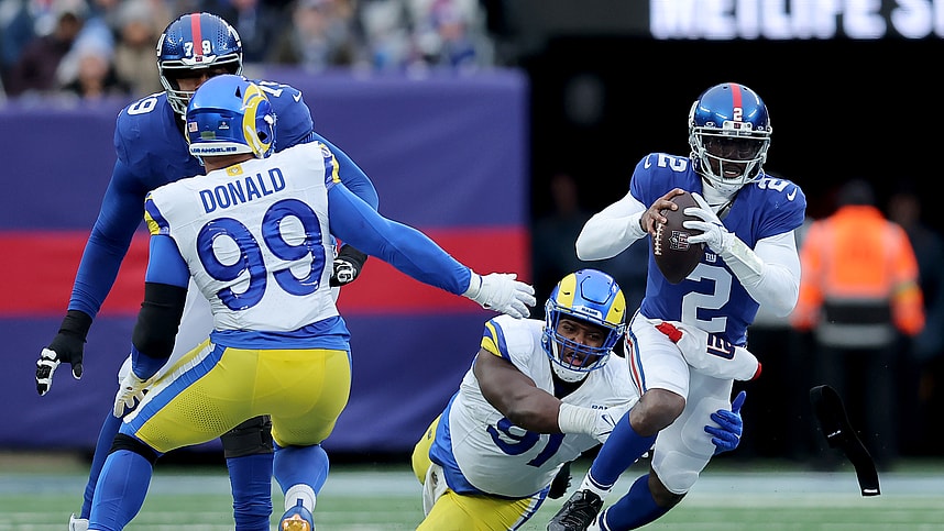 New York Giants quarterback Tyrod Taylor (2) is sacked by Los Angeles Rams defensive tackles Kobie Turner (91) and Aaron Donald (99) during the third quarter at MetLife Stadium