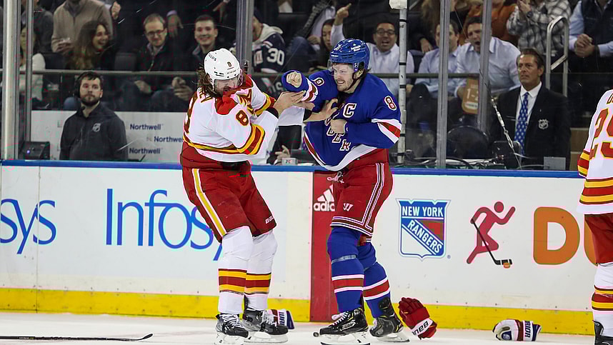 New York Rangers defenseman Jacob Trouba (8) and Calgary Flames defenseman Chris Tanev (8) fight during the first period at Madison Square Garden