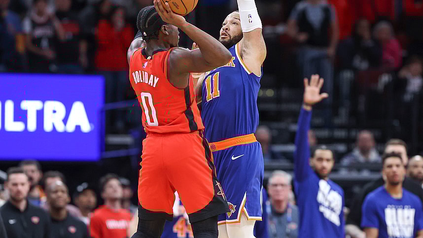 New York Knicks guard Jalen Brunson (11) fouls Houston Rockets guard Aaron Holiday (0) on a play in the final moments of the fourth quarter at Toyota Center