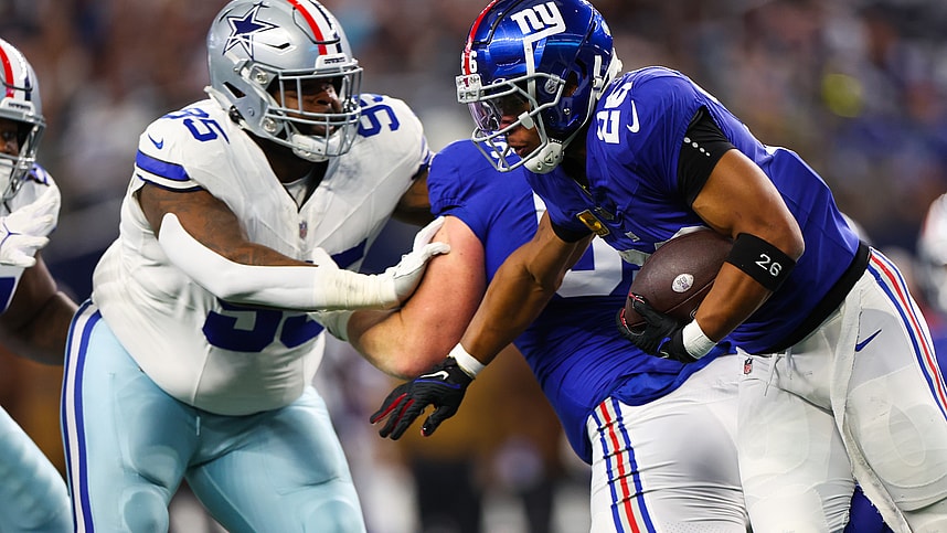 New York Giants running back Saquon Barkley (26) runs with the ball as Dallas Cowboys defensive tackle Johnathan Hankins (95) defends during the first quarter at AT&T Stadium