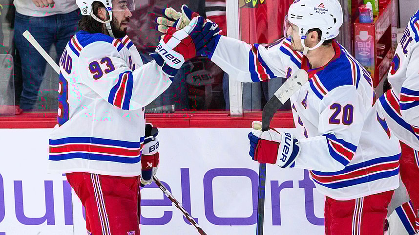 New York Rangers center Mika Zibanejad (93) celebrates with center Rem Pitlick (20) against the Chicago Blackhawks after the game at the United Center
