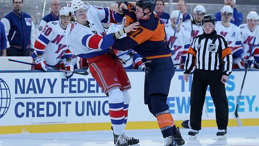 New York Rangers center Matt Rempe (73) and New York Islanders left wing Matt Martin (17) fight during the first period of a Stadium Series ice hockey game at MetLife Stadium