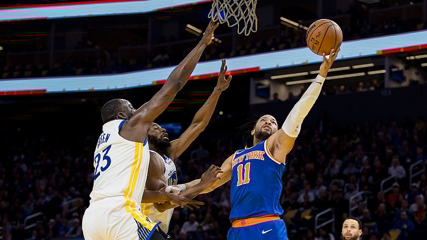 New York Knicks guard Jalen Brunson (11) shoots as Golden State Warriors center Draymond Green (23) and forward Andrew Wiggins (22) defend during the first half at Chase Center