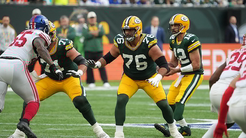 Green Bay Packers guard Jon Runyan (76) blocks as quarterback Aaron Rodgers (12) drops back to pass against the New York Giants during an NFL International Series game at Tottenham Hotspur Stadium