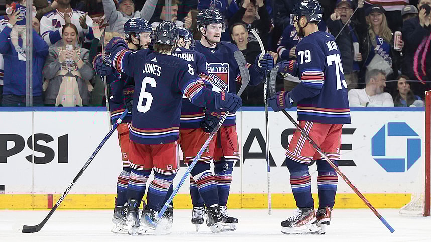 New York Rangers left wing Alexis Lafreniere (13) celebrates his goal with teammates during the third period against the New York Islanders at Madison Square Garden