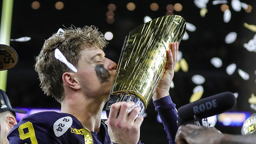 Michigan quarterback J.J. McCarthy kisses the championship trophy to celebrate the Wolverines' 34-13 win over Washington in the national championship game at NRG Stadium in Houston (New York Giants prospect)