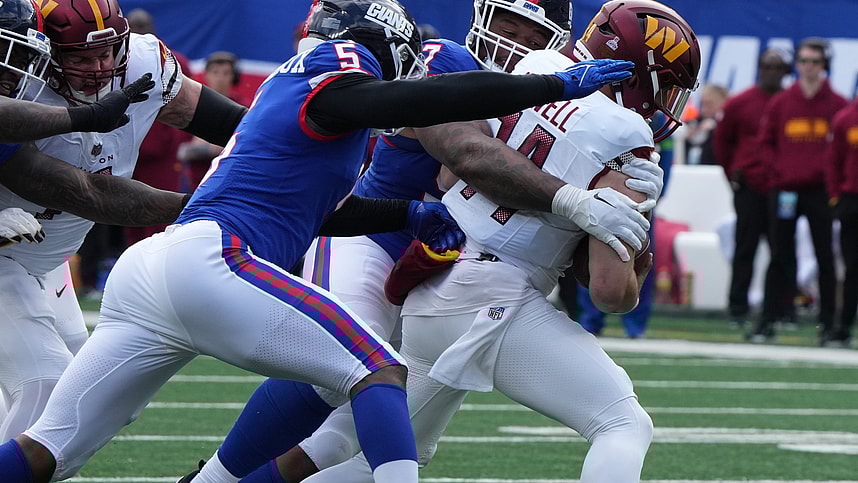 Dexter Lawrence and Kayvon Thibodeaux of the Giants sack Sam Howell of the Commanders in the first half. The NY Giants host the Washington Commanders at MetLife Stadium