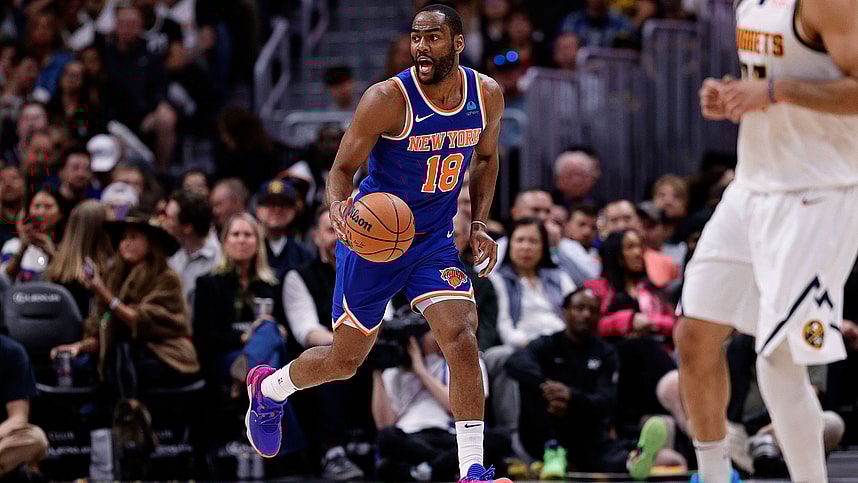 New York Knicks guard Alec Burks (18) dribbles the ball up court in the fourth quarter against the Denver Nuggets at Ball Arena