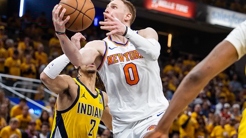 May 17, 2024; Indianapolis, Indiana, USA; New York Knicks guard Donte DiVincenzo (0) shoots the ball while Indiana Pacers guard Andrew Nembhard (2) defends during game six of the second round for the 2024 NBA playoffs at Gainbridge Fieldhouse. Mandatory Credit: Trevor Ruszkowski-USA TODAY Sports