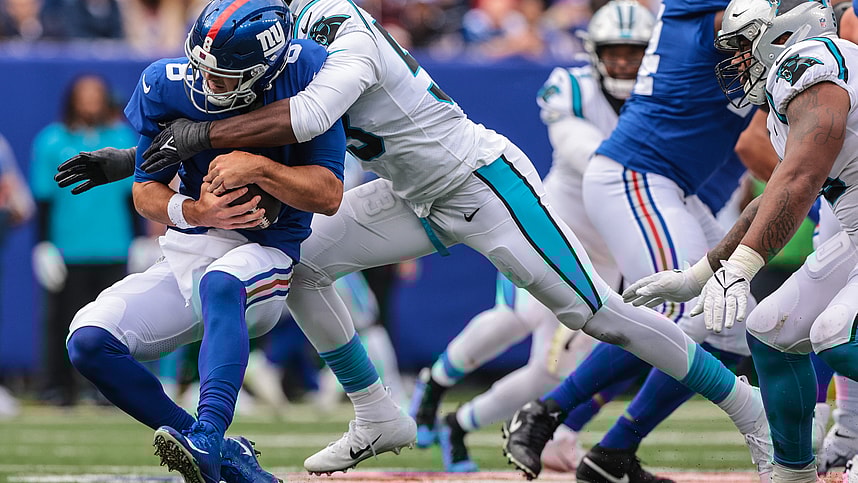 Oct 24, 2021; East Rutherford, New Jersey, USA; New York Giants quarterback Daniel Jones (8) is sacked by Carolina Panthers defensive end Brian Burns (53) during the first half at MetLife Stadium. Mandatory Credit: Vincent Carchietta-USA TODAY Sports