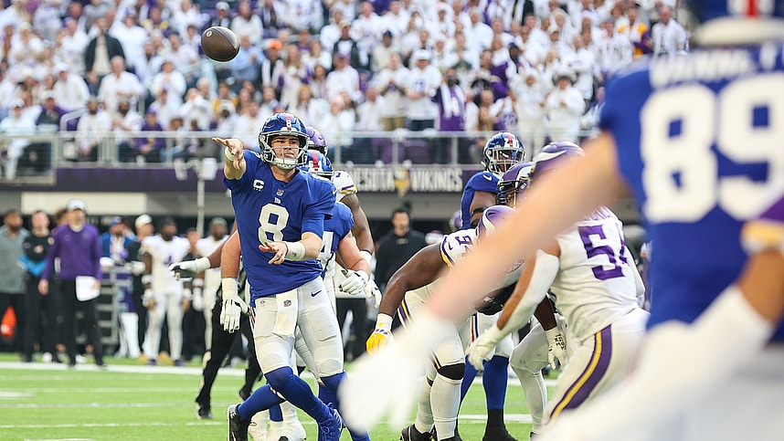 Dec 24, 2022; Minneapolis, Minnesota, USA; New York Giants quarterback Daniel Jones (8) throws a touchdown pass during the second quarter against the Minnesota Vikings at U.S. Bank Stadium. Mandatory Credit: Matt Krohn-USA TODAY Sports