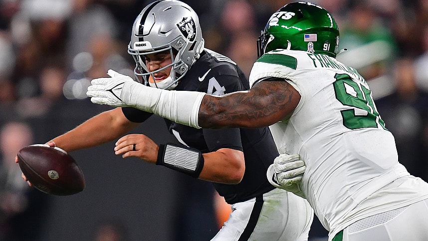 Nov 12, 2023; Paradise, Nevada, USA; Las Vegas Raiders quarterback Aidan O'Connell (4) comes under pressure from New York Jets defensive end John Franklin-Myers (91) during the first half at Allegiant Stadium. Mandatory Credit: Gary A. Vasquez-USA TODAY Sports