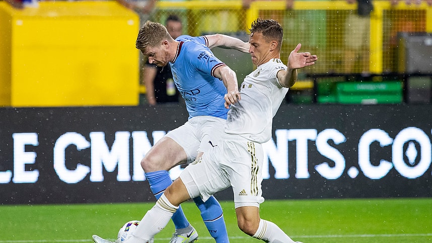 Manchester City midfielder Kevin De Bruyne (17) and FC Bayern Munich midfielder Joshua Kimmich (6) fight for the ball during the exhibition match on Saturday, July 23, 2022, at Lambeau Field in Green Bay, Wis.