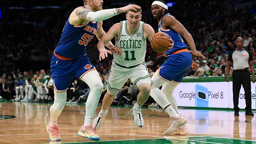 Apr 11, 2024; Boston, Massachusetts, USA;  Boston Celtics guard Payton Pritchard (11) controls the ball while New York Knicks center Isaiah Hartenstein (55) and forward Precious Achiuwa (5) defend during the second half at TD Garden. Mandatory Credit: Bob DeChiara-USA TODAY Sports