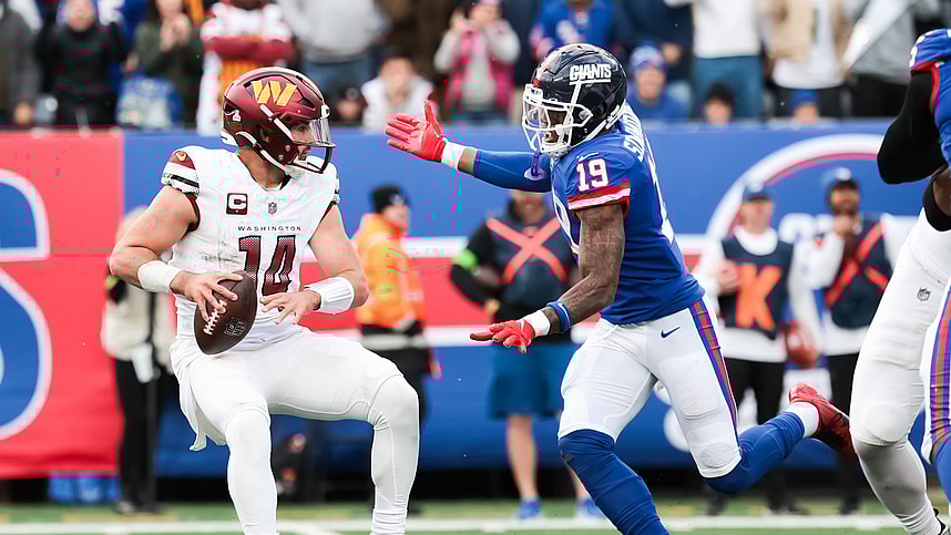 Oct 22, 2023; East Rutherford, New Jersey, USA; Washington Commanders quarterback Sam Howell (14) is pressured by New York Giants safety Isaiah Simmons (19) during the fourth quarter at MetLife Stadium. Mandatory Credit: Vincent Carchietta-USA TODAY Sports