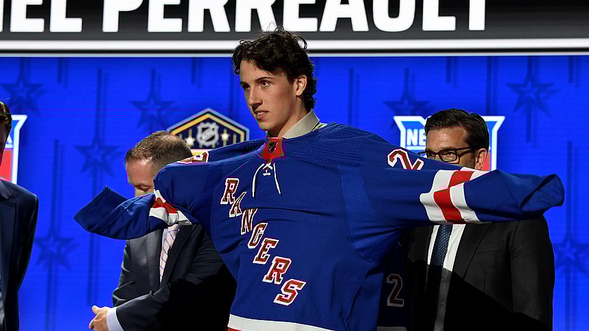 Jun 28, 2023; Nashville, Tennessee, USA; New York Rangers draft pick Gabriel Perreault puts on his sweater after being selected with the twenty third pick in round one of the 2023 NHL Draft at Bridgestone Arena. Mandatory Credit: Christopher Hanewinckel-USA TODAY Sports