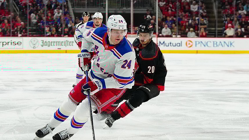 May 11, 2024; Raleigh, North Carolina, USA; New York Rangers right wing Kaapo Kakko (24) skates with the puck against Carolina Hurricanes center Sebastian Aho (20) during the second period in game four of the second round of the 2024 Stanley Cup Playoffs at PNC Arena. Mandatory Credit: James Guillory-USA TODAY Sports