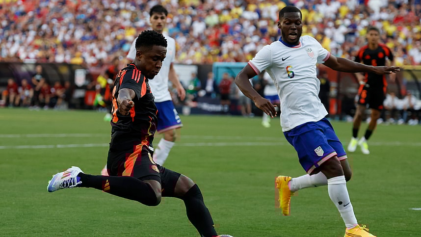 Jun 8, 2024; Landover, Maryland, USA; Colombia forward Rafael Santtos Borre (19) crosses the ball as United States defender Antonee Robinson (5) defends in the second half at Commanders Field. Mandatory Credit: Geoff Burke-USA TODAY Sports