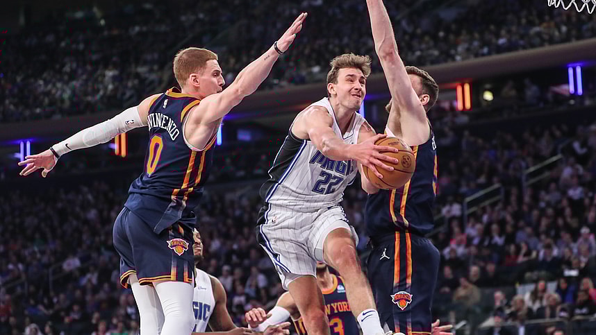 Mar 8, 2024; New York, New York, USA;  Orlando Magic forward Franz Wagner (22) drives in between New York Knicks guard Donte DiVincenzo (0) and center Isaiah Hartenstein (55) in the first quarter at Madison Square Garden. Mandatory Credit: Wendell Cruz-USA TODAY Sports