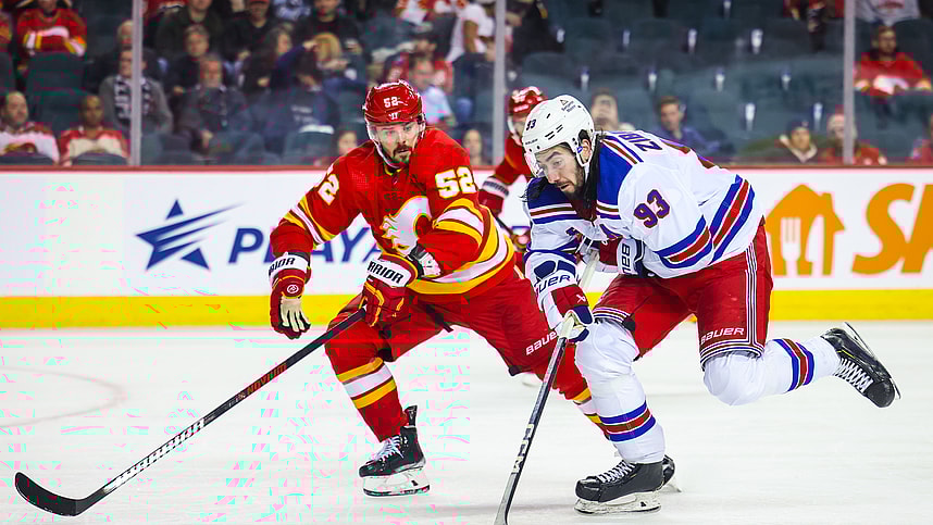 Oct 24, 2023; Calgary, Alberta, CAN; New York Rangers center Mika Zibanejad (93) and Calgary Flames defenseman MacKenzie Weegar (52) battle for the puck during the third period at Scotiabank Saddledome. Mandatory Credit: Sergei Belski-USA TODAY Sports