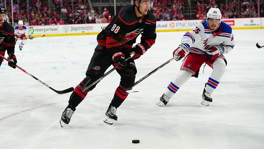 May 9, 2024; Raleigh, North Carolina, USA; Carolina Hurricanes center Martin Necas (88) skates with the puck past New York Rangers defenseman Ryan Lindgren (55) during the third period in game three of the second round of the 2024 Stanley Cup Playoffs at PNC Arena. Mandatory Credit: James Guillory-USA TODAY Sports