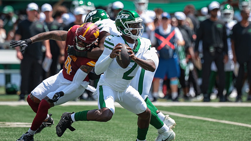 Aug 10, 2024; East Rutherford, New Jersey, USA; New York Jets quarterback Tyrod Taylor (2) looks to pass as Washington Commanders linebacker Frankie Luvu (4) defends during the first quarter at MetLife Stadium. Mandatory Credit: Vincent Carchietta-USA TODAY Sports
