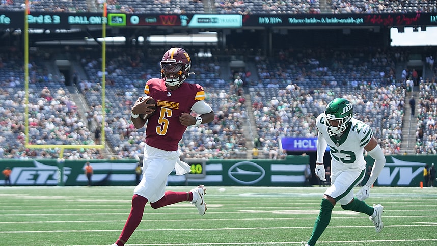 Aug 10, 2024; East Rutherford, New Jersey, USA; Washington Commanders quarterback Jayden Daniels (5) rushes for a touchdown during the first quarter against the New York Jets at MetLife Stadium. Mandatory Credit: Lucas Boland-USA TODAY Sports