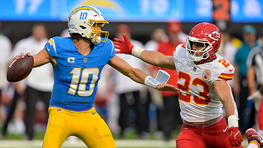 Sep 29, 2024; Inglewood, California, USA; Los Angeles Chargers quarterback Justin Herbert (10) throws an incomplete pas as is pressured by Kansas City Chiefs linebacker Drue Tranquill (23) at SoFi Stadium. Mandatory Credit: Jayne Kamin-Oncea-Imagn Images