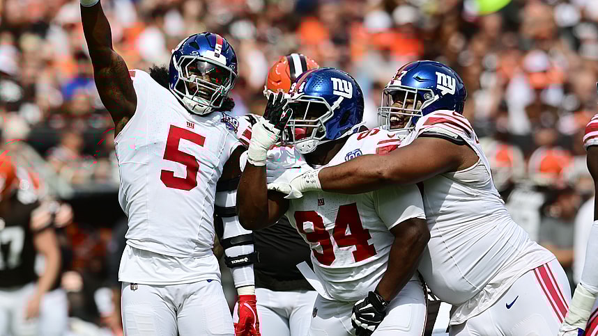 Sep 22, 2024; Cleveland, Ohio, USA; New York Giants linebacker Kayvon Thibodeaux (5) and defensive tackle Elijah Chatman (94) and defensive tackle Dexter Lawrence II (97) celebrate after sacking Cleveland Browns quarterback Deshaun Watson (not pictured) during the first quarter at Huntington Bank Field. Mandatory Credit: Ken Blaze-Imagn Images