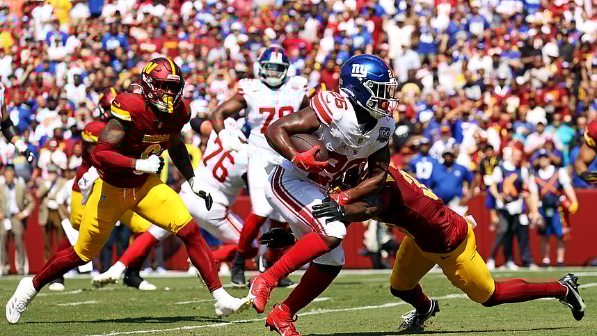 Sep 15, 2024; Landover, Maryland, USA; New York Giants running back Devin Singletary (26) runs for a touchdown during the first quarter against the Washington Commanders at Commanders Field. Mandatory Credit: Peter Casey-Imagn Images