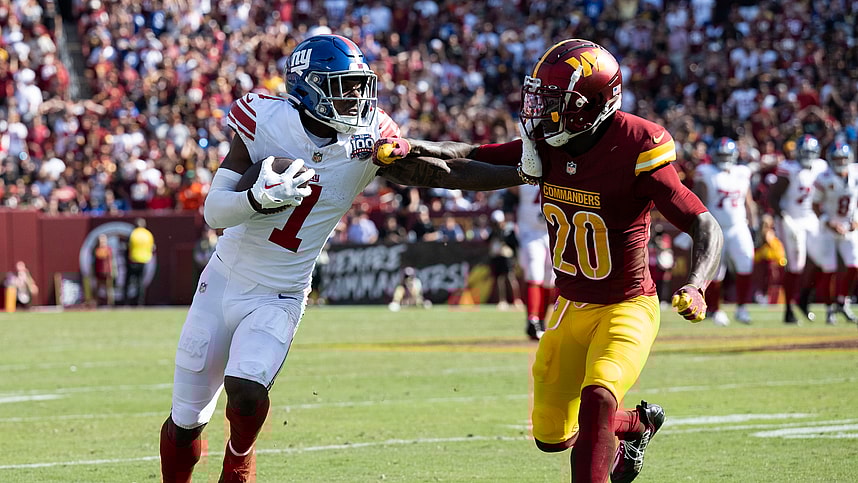 Sep 15, 2024; Landover, Maryland, USA; New York Giants wide receiver Malik Nabers (1) stiff arms Washington Commanders safety Quan Martin (20) in the second half at Commanders Field. Mandatory Credit: Luke Johnson-Imagn Images