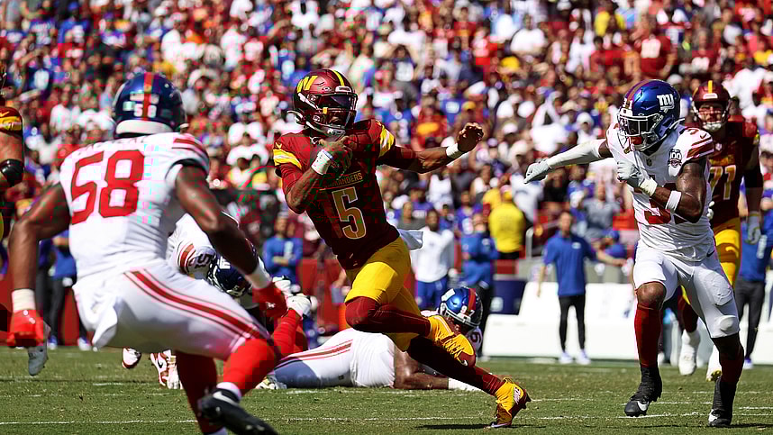 Sep 15, 2024; Landover, Maryland, USA; Washington Commanders quarterback Jayden Daniels (5) runs the ball against New York Giants safety Tyler Nubin (31) and linebacker Bobby Okereke (58) during the fourth quarter at Commanders Field. Mandatory Credit: Peter Casey-Imagn Images