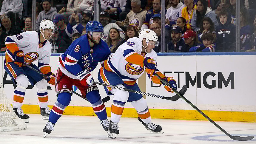 Sep 24, 2024; New York, New York, USA; New York Islanders center Kyle McLean (32) is defended by New York Rangers defenseman Zac Jones (6) during the second period at Madison Square Garden. Mandatory Credit: Danny Wild-Imagn Images