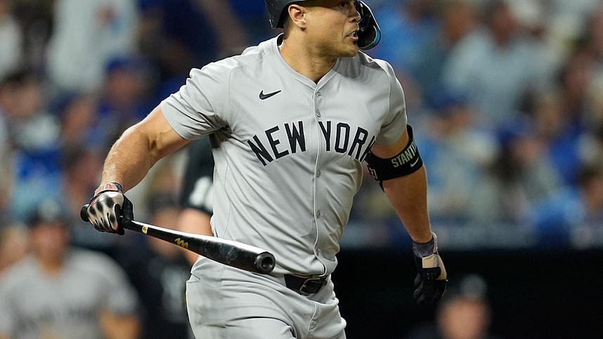 Oct 9, 2024; Kansas City, Missouri, USA; New York Yankees designated hitter Giancarlo Stanton (27) hits a home run in the eighth inning against the Kansas City Royals during game three of the NLDS for the 2024 MLB Playoffs at Kauffman Stadium. Mandatory Credit: Jay Biggerstaff -Imagn Images