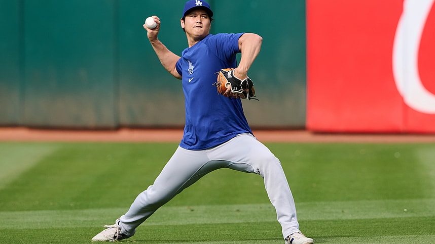 Aug 2, 2024; Oakland, California, USA; Los Angeles Dodgers designated hitter Shohei Ohtani (17) throws the ball in the outfield during warmups before the game between the Los Angeles Dodgers and the Oakland Athletics at Oakland-Alameda County Coliseum. Mandatory Credit: Robert Edwards-Imagn Images