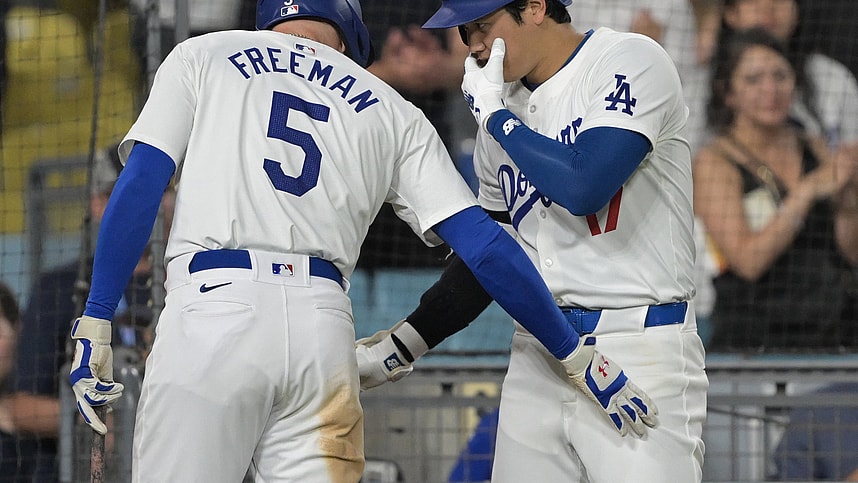 Aug 5, 2024; Los Angeles, California, USA; Los Angeles Dodgers designated hitter Shohei Ohtani (17) talks with first baseman Freddie Freeman (5) after hitting a solo home run in the eighth inning against the Philadelphia Phillies at Dodger Stadium. Mandatory Credit: Jayne Kamin-Oncea-Imagn Images
