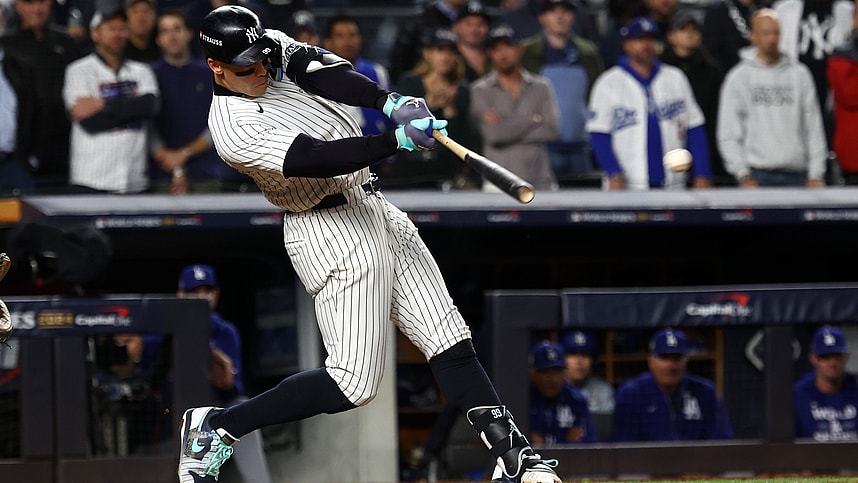 Oct 29, 2024; Bronx, New York, USA; New York Yankees outfielder Aaron Judge (99) hits a single against the Los Angeles Dodgers in the eighth inning during game four of the 2024 MLB World Series at Yankee Stadium. Mandatory Credit: Robert Deutsch-Imagn Images
