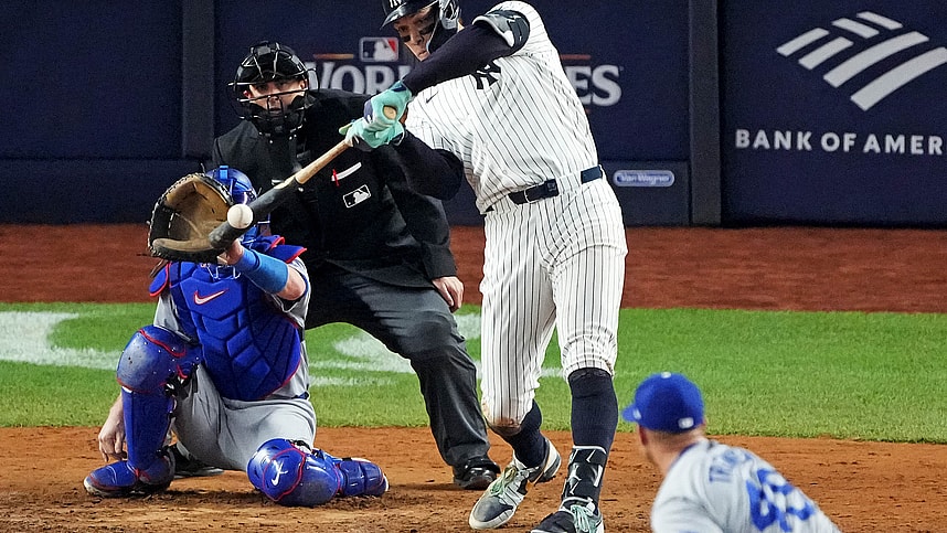 Oct 30, 2024; New York, New York, USA; New York Yankees outfielder Aaron Judge (99) hits a double during the eighth inning against the Los Angeles Dodgers in game four of the 2024 MLB World Series at Yankee Stadium. Mandatory Credit: Robert Deutsch-Imagn Images
