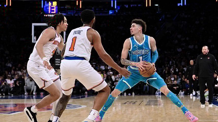 Oct 15, 2024; New York, New York, USA; Charlotte Hornets guard LaMelo Ball (1) sets the play as New York Knicks guard Pacome Dadiet (4) and New York Knicks guard Cameron Payne (1) defend during the second half at Madison Square Garden. Mandatory Credit: John Jones-Imagn Images
