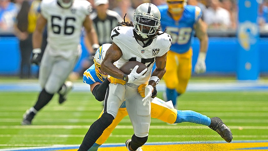 Sep 8, 2024; Inglewood, California, USA; Las Vegas Raiders wide receiver Davante Adams (17) is stopped by Los Angeles Chargers safety Alohi Gilman (32) after a compete pass in the first half at SoFi Stadium. Mandatory Credit: Jayne Kamin-Oncea-Imagn Images