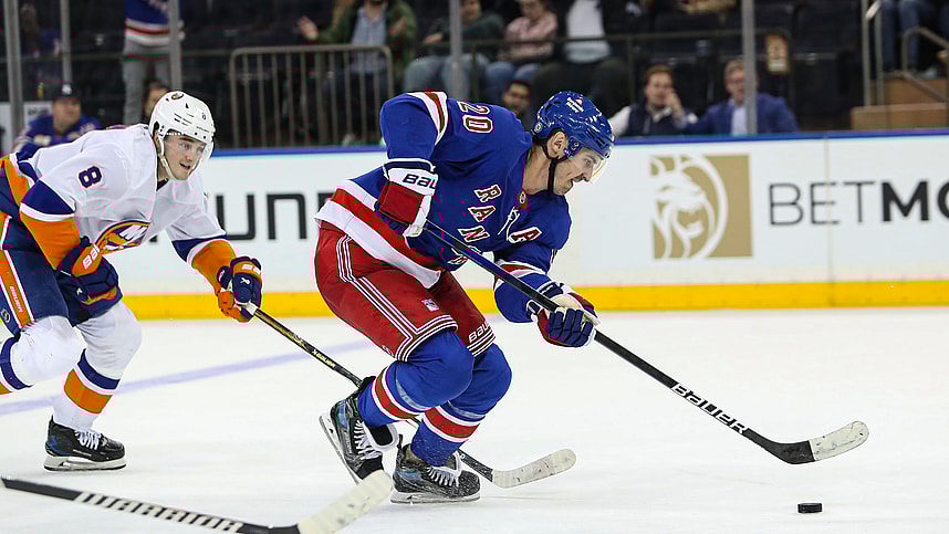 Sep 24, 2024; New York, New York, USA; New York Rangers left wing Chris Kreider (20) scores an empty-net goal while New York Islanders defenseman Noah Dobson (8) chases during the third period at Madison Square Garden. Mandatory Credit: Danny Wild-Imagn Images
