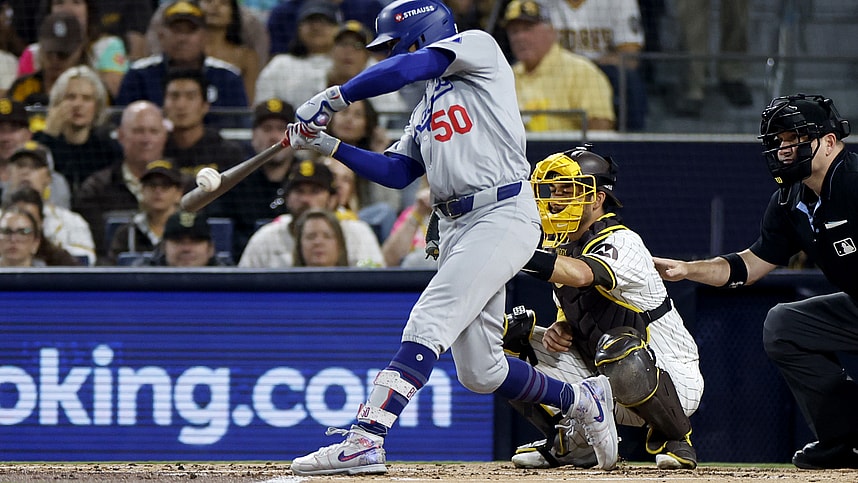 Oct 9, 2024; San Diego, California, USA; Los Angeles Dodgers shortstop Mookie Betts (50) hits a RBI single in the second inning against the San Diego Padres during game four of the NLDS for the 2024 MLB Playoffs at Petco Park. Mandatory Credit: David Frerker-Imagn Images