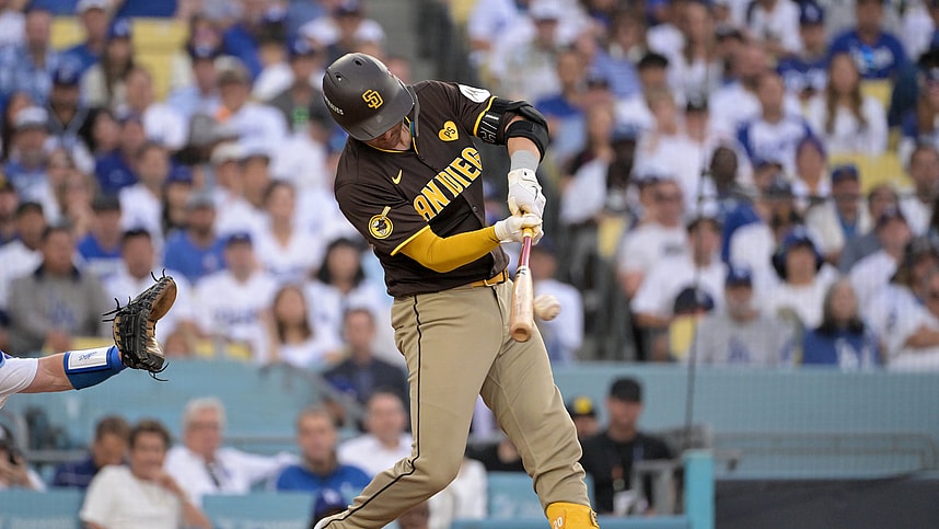 Oct 11, 2024; Los Angeles, California, USA; San Diego Padres catcher Kyle Higashioka (20) hits a single in the third inning against the Los Angeles Dodgers during game five of the NLDS for the 2024 MLB Playoffs at Dodger Stadium. Mandatory Credit: Jayne Kamin-Oncea-Imagn Images
