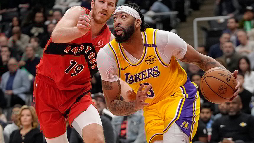 Nov 1, 2024; Toronto, Ontario, CAN; Los Angeles Lakers forward Anthony Davis (3) drives to the net past Toronto Raptors center Jakob Poeltl (19) during the first half at Scotiabank Arena. Mandatory Credit: John E. Sokolowski-Imagn Images