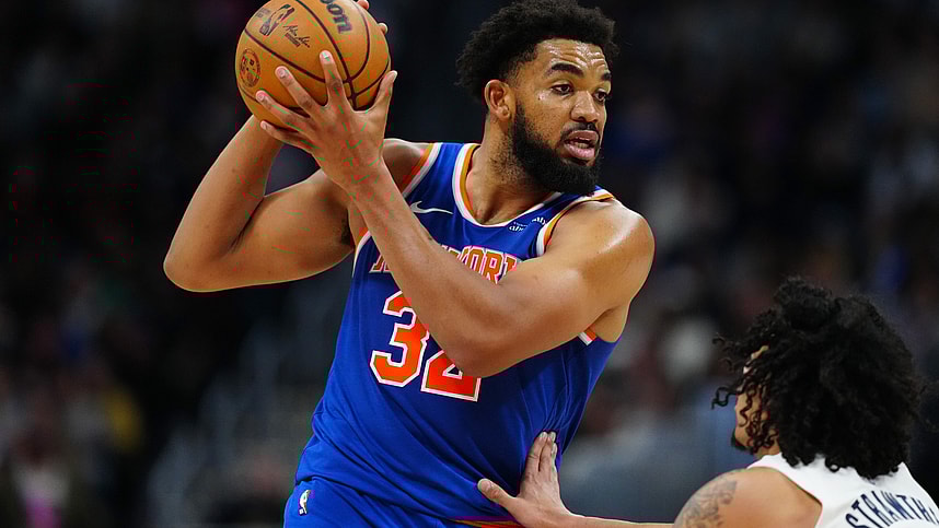 Nov 25, 2024; Denver, Colorado, USA; New York Knicks center Karl-Anthony Towns (32) controls the ball over Denver Nuggets guard Julian Strawther (3) in the second half at Ball Arena. Mandatory Credit: Ron Chenoy-Imagn Images