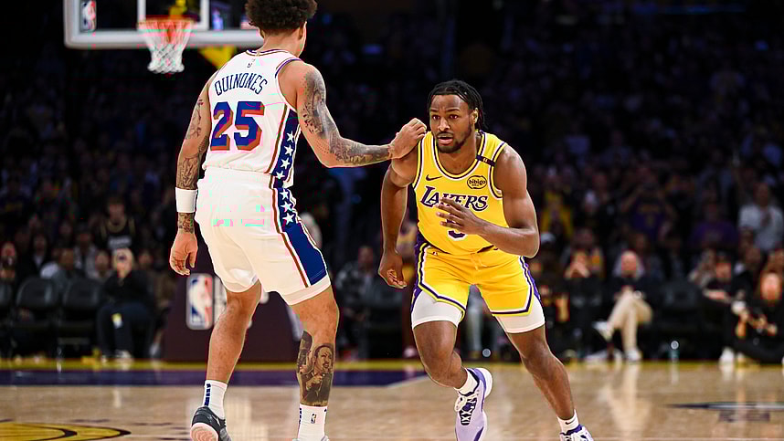 Nov 8, 2024; Los Angeles, California, USA; Los Angeles Lakers guard Bronny James (9) runs past Philadelphia 76ers guard Lester Quinones (25) during the second half at Crypto.com Arena. Mandatory Credit: Jonathan Hui-Imagn Images