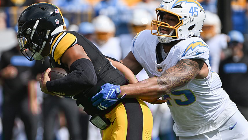 Sep 22, 2024; Pittsburgh, Pennsylvania, USA; Pittsburgh Steelers quarterback Justin Fields (2) is tackled by Los Angeles Chargers linebacker Tuli Tuipulotu (45) during the first quarter at Acrisure Stadium. Mandatory Credit: Barry Reeger-Imagn Images