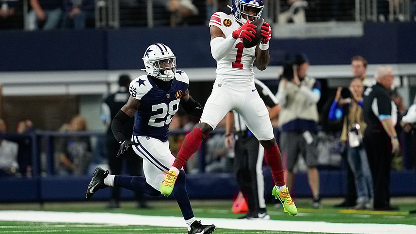 Nov 28, 2024; Arlington, Texas, USA; New York Giants wide receiver Malik Nabers (1) catches a pass as Dallas Cowboys safety Malik Hooker (28) gives chase during the first half at AT&T Stadium. Mandatory Credit: Chris Jones-Imagn Images